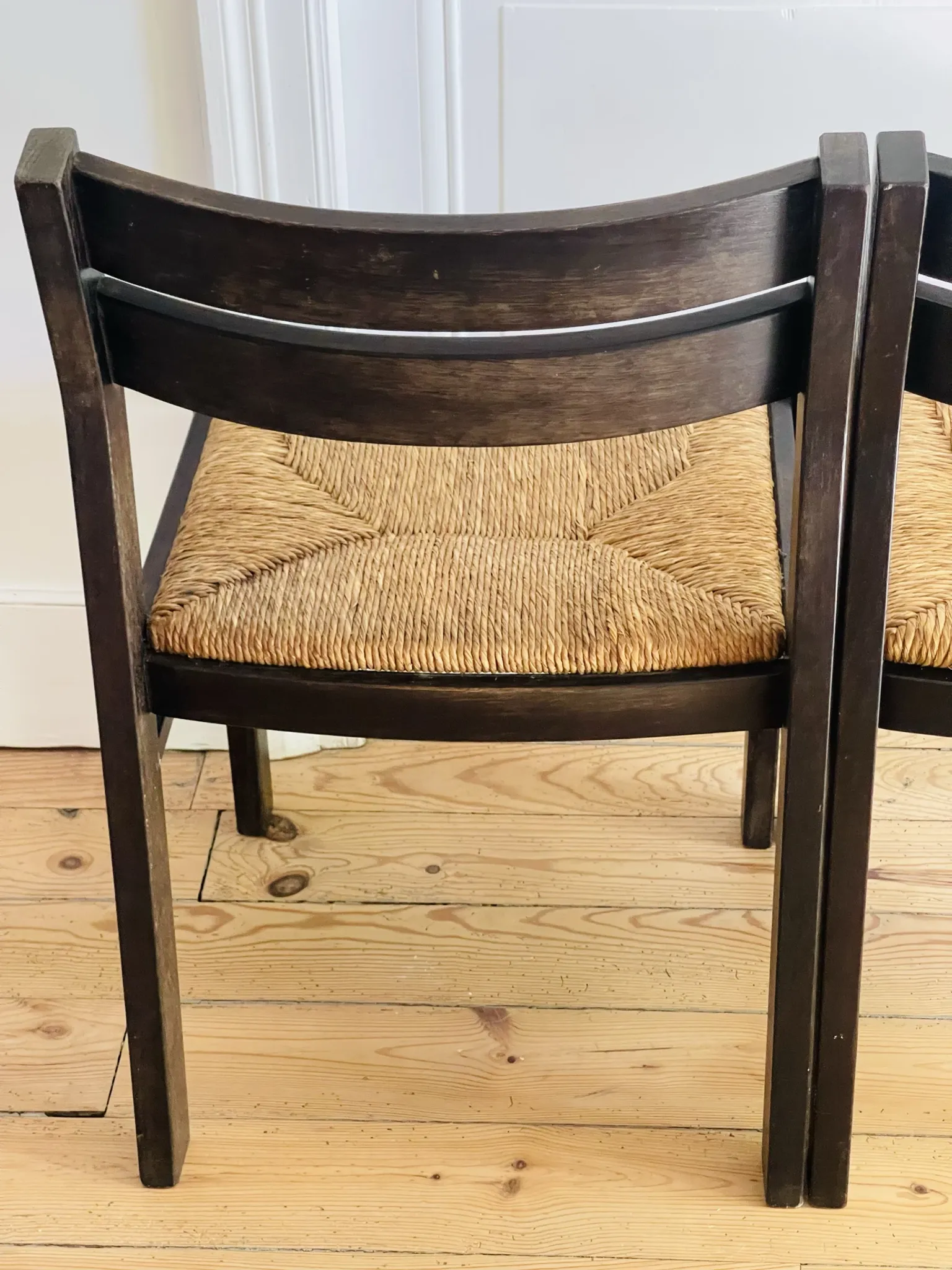 Pair of straw-seated wooden chairs in the regain style.