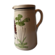 A pitcher in earthenware with a country décor