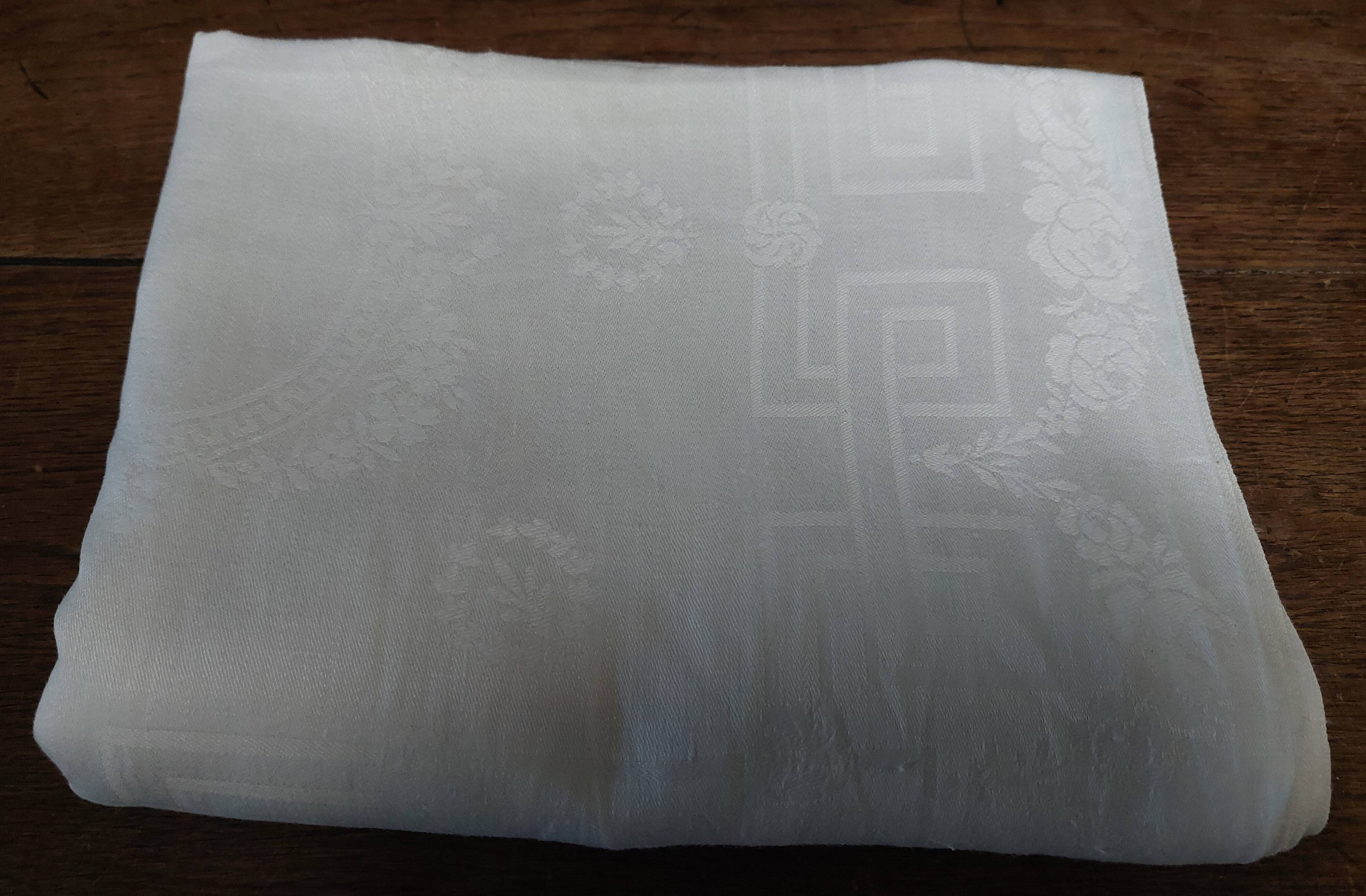 Table napkins set of eleven in a single piece damask linen and silk early 20th century.