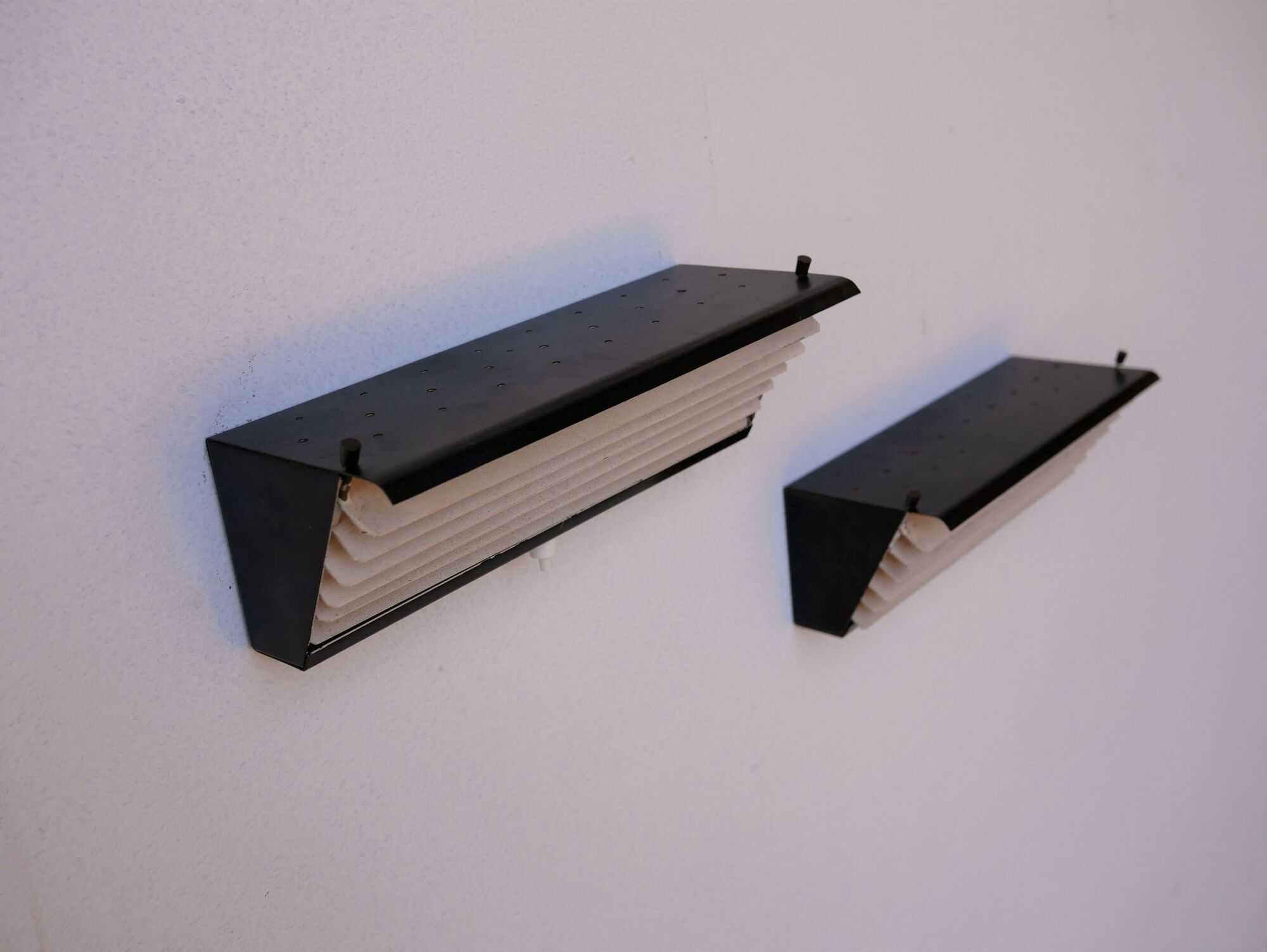 Pair of modernist metal wall light model 212, by Jacques Biny for Luminalite