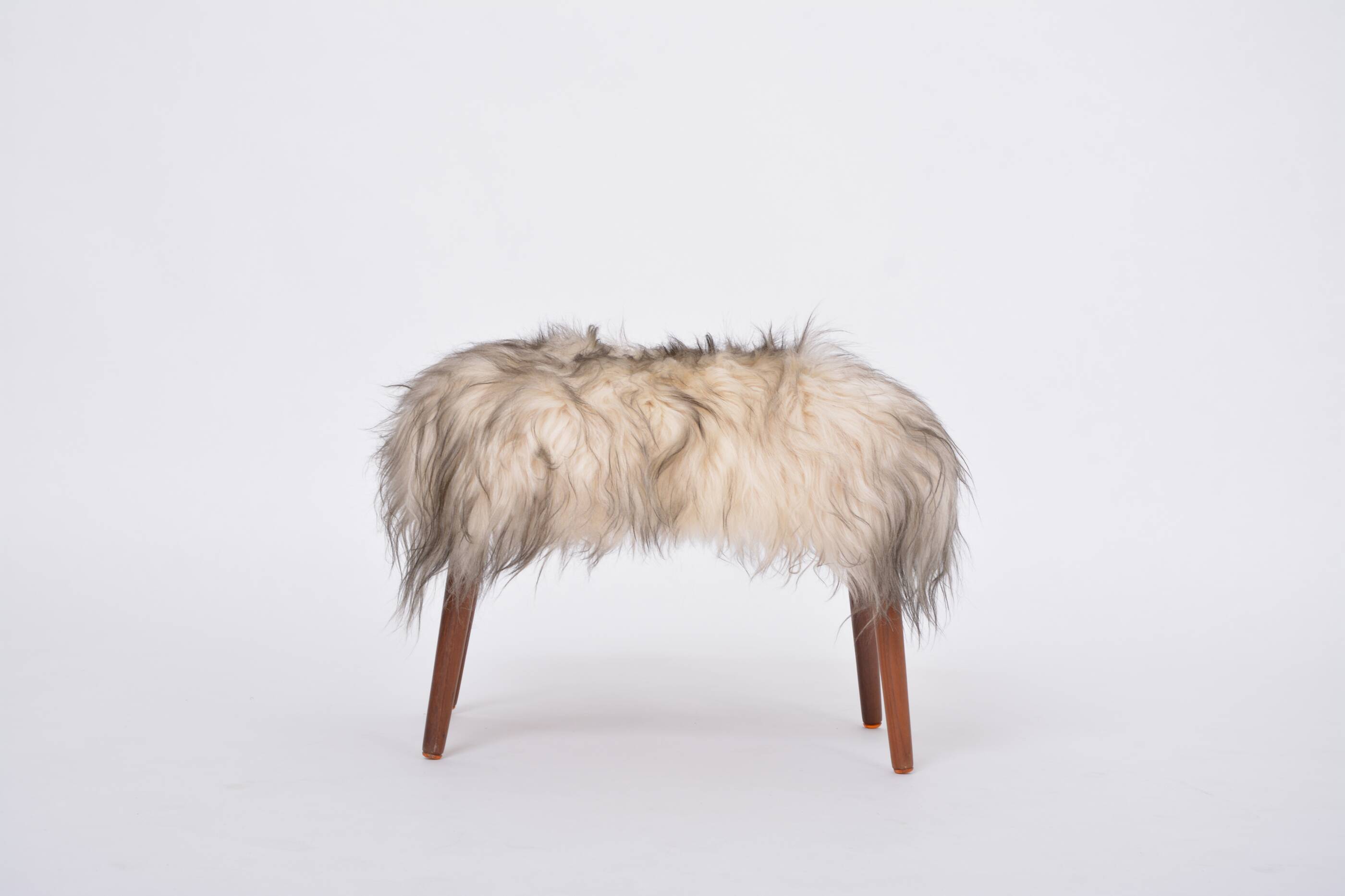 Danish Mid-century Modern stool reupholstered in white and black sheep skin