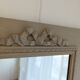 Wooden mirror with patinated beige knot