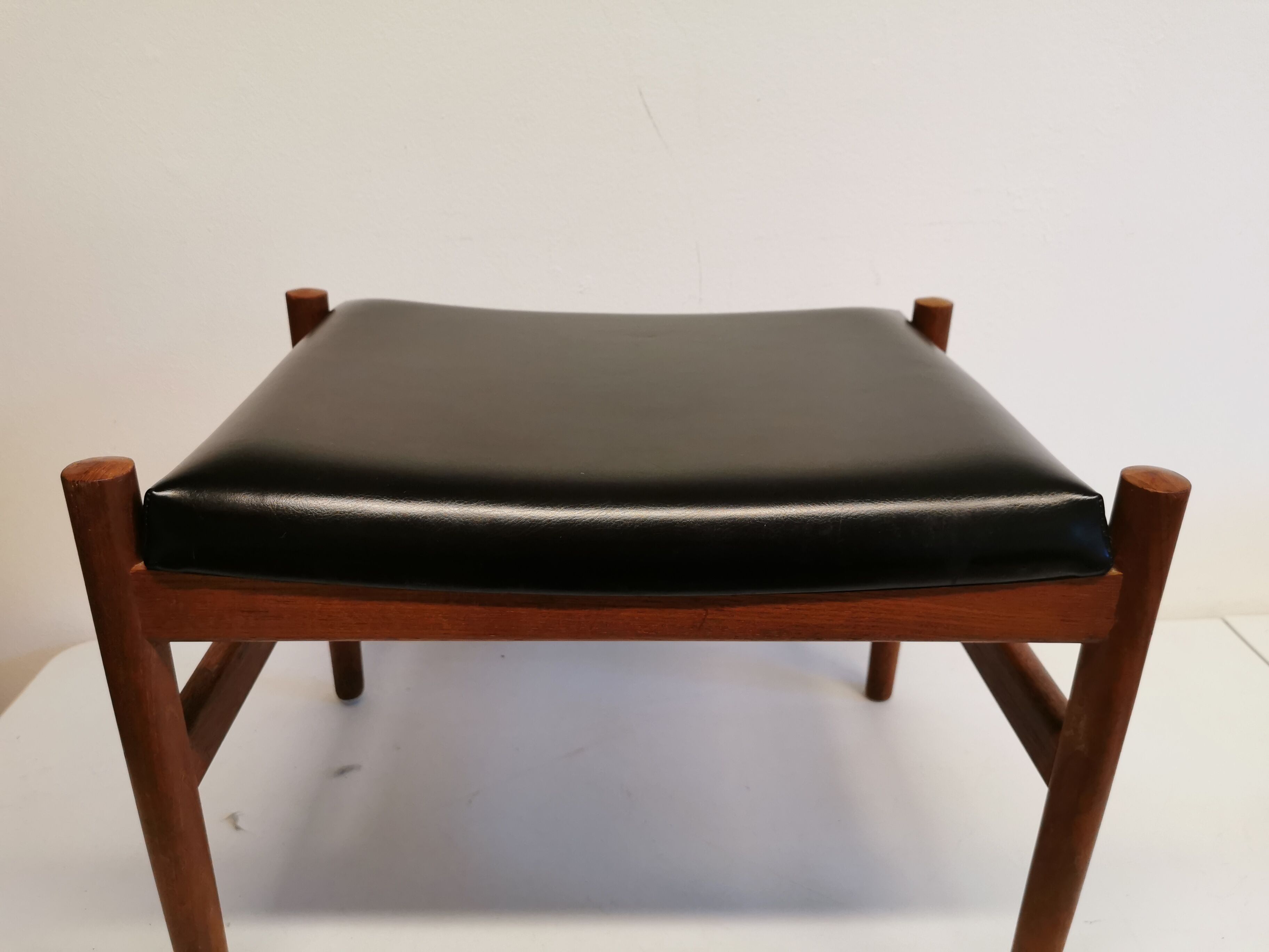 Danish designed footstool, in teak and black skai. Made at Spøttrup furniture factory in the 1960s.