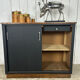 Small vintage black buffet with sliding doors.