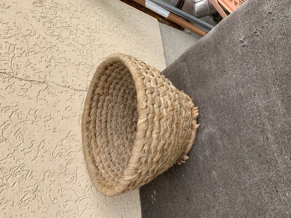 Brown woven wicker basket for collecting eggs — France, 1940s