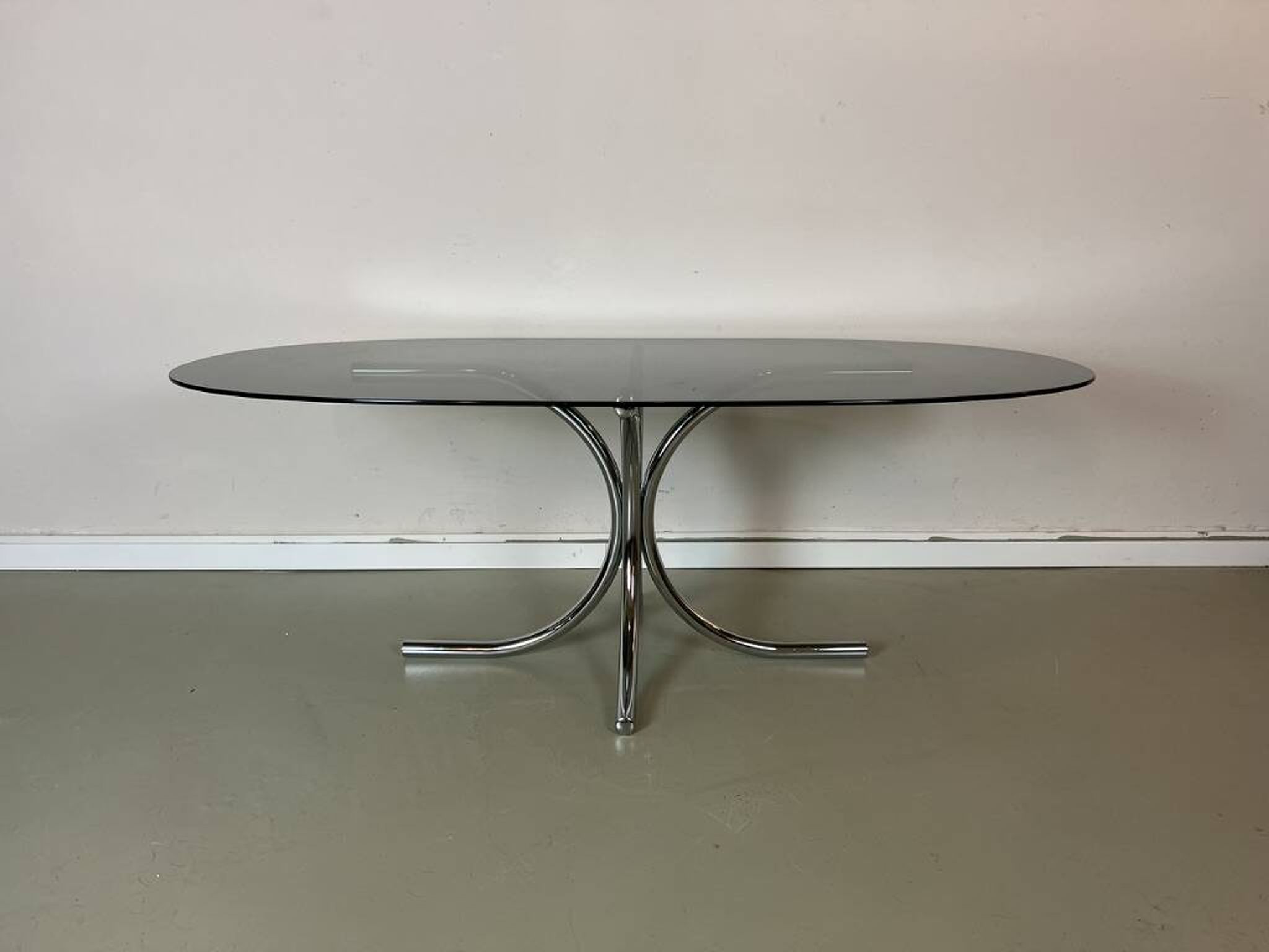 Vintage coffee table from the 70s in smoked glass and chrome, oval, Space Age style.