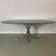 Vintage coffee table from the 70s in smoked glass and chrome, oval, Space Age style.