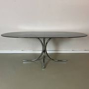 Vintage coffee table from the 70s in smoked glass and chrome, oval, Space Age style.