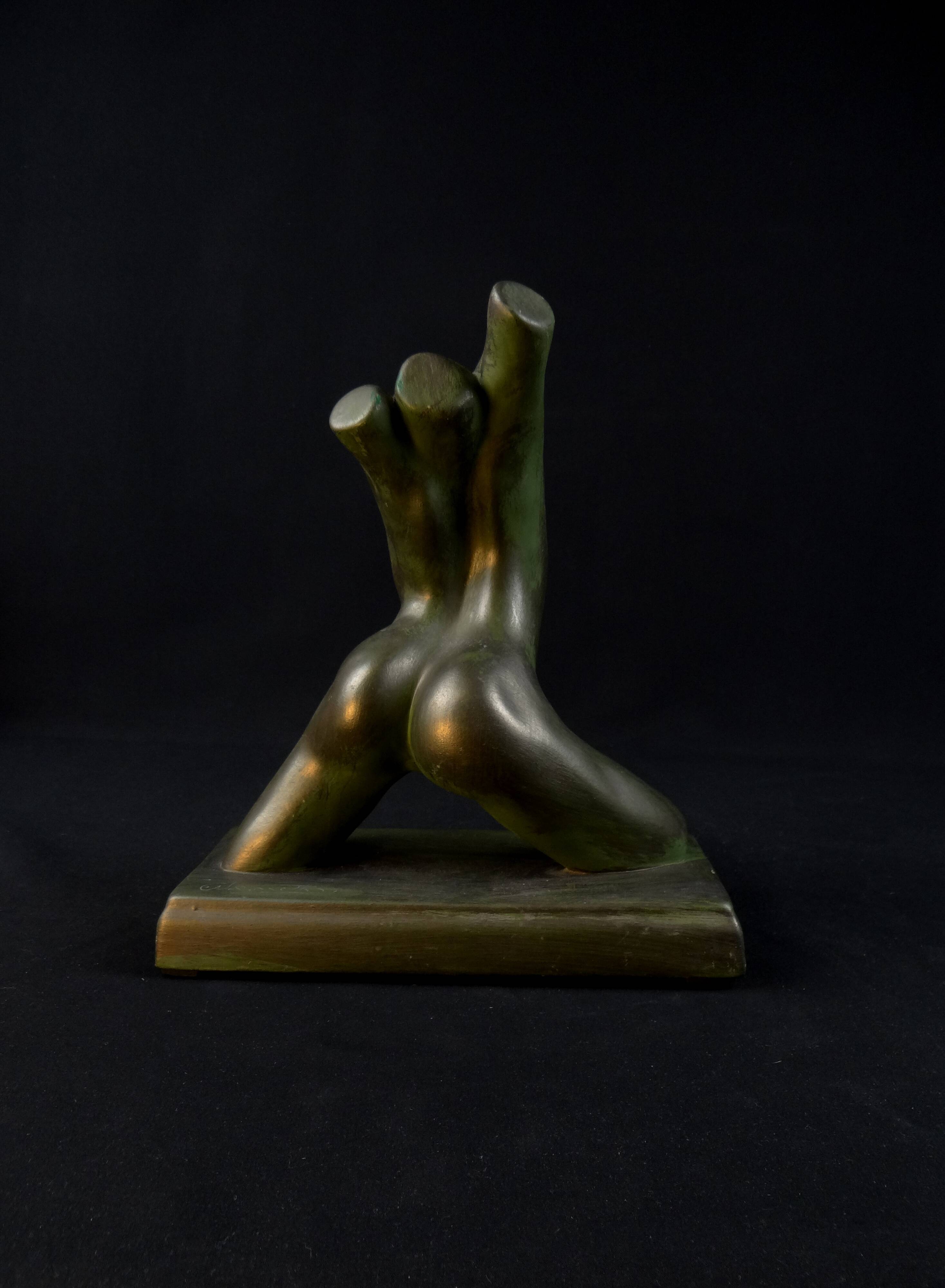 Modern sculpture of a nude woman in green ceramic, signed Carlos Nazareth
