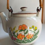 Flowered stoneware teapot with vintage rattan handle