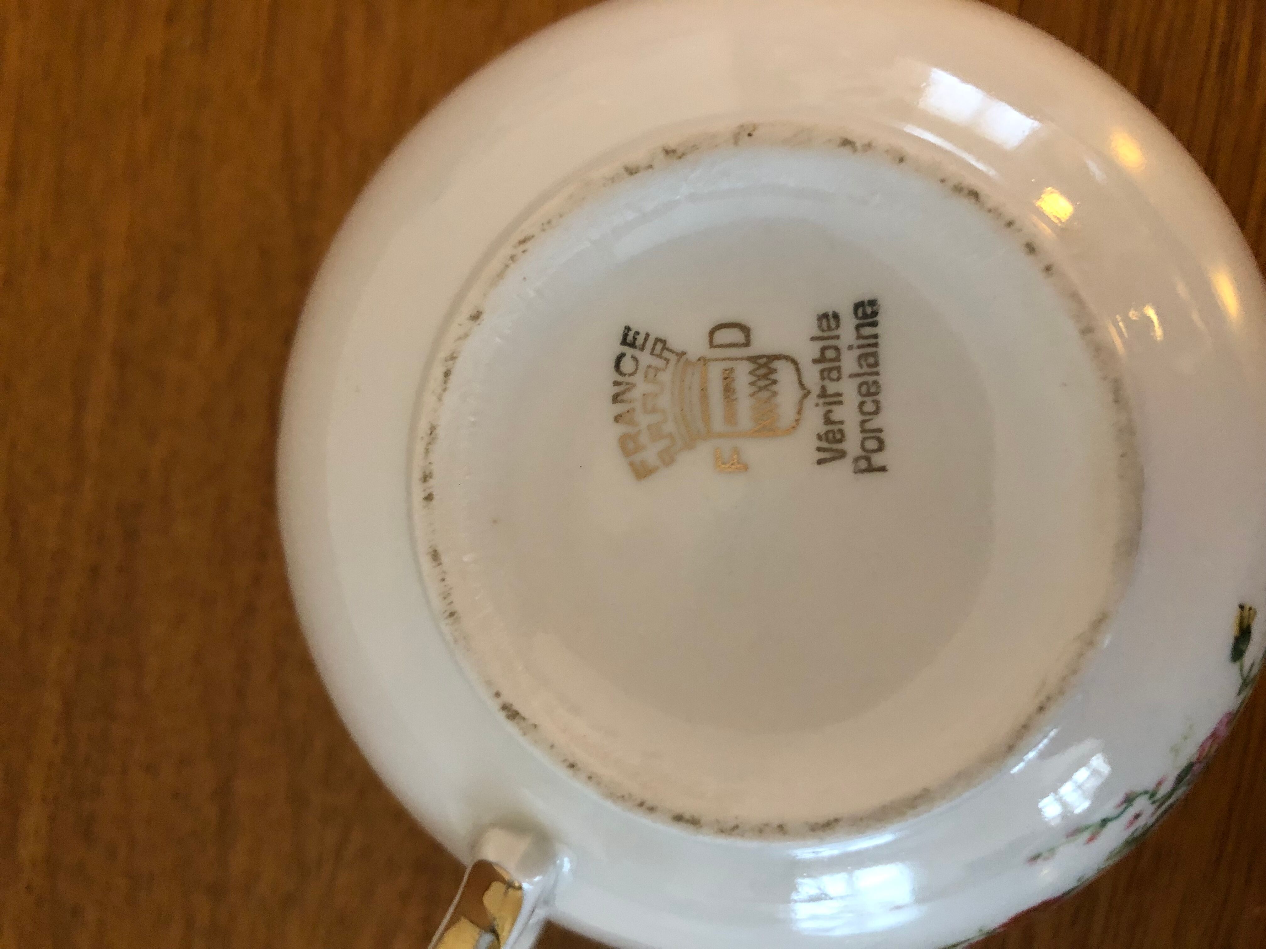 2 porcelain teacups and under teacups floral motifs