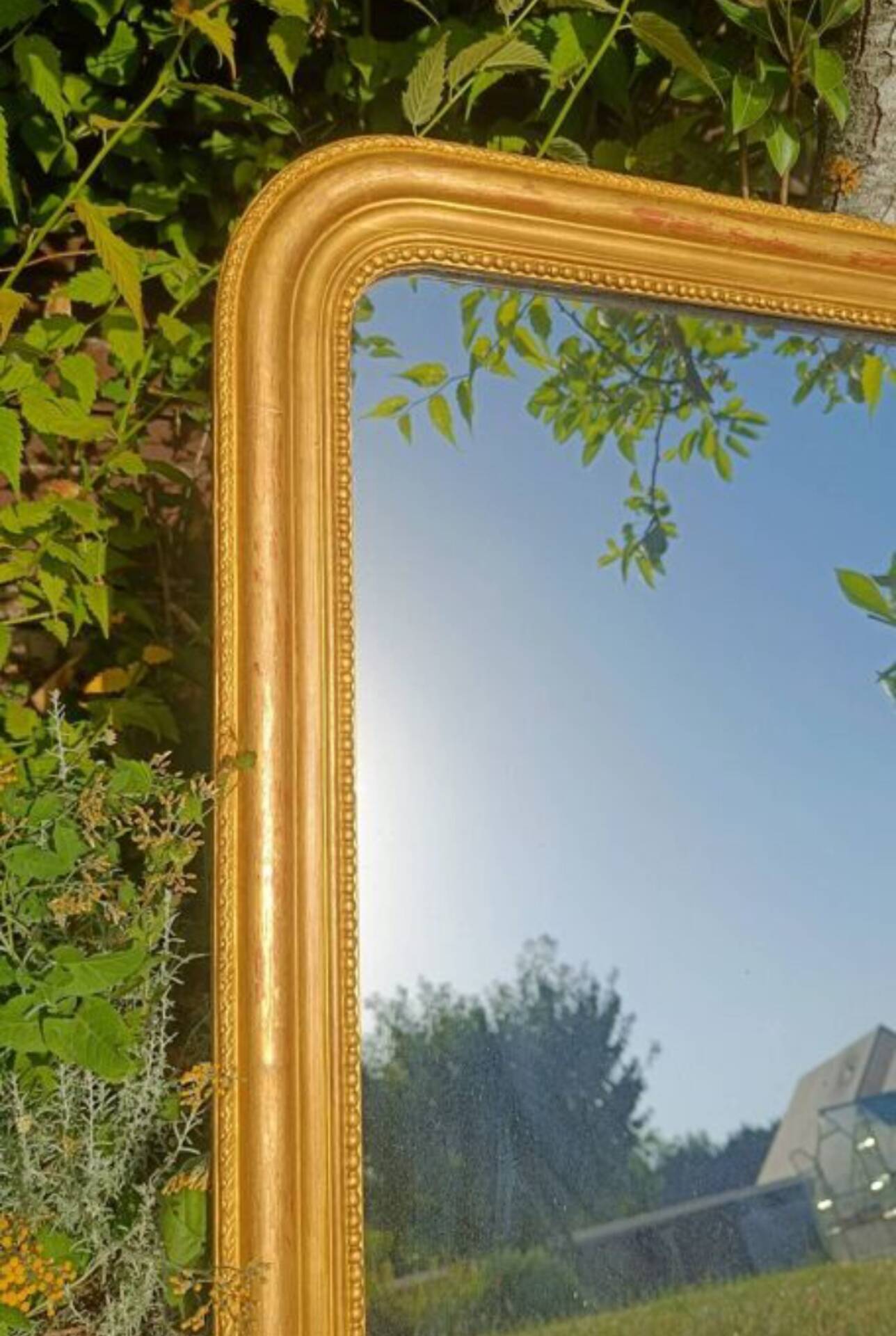 Antique Louis-Philippe mirror, gilded and patinated.