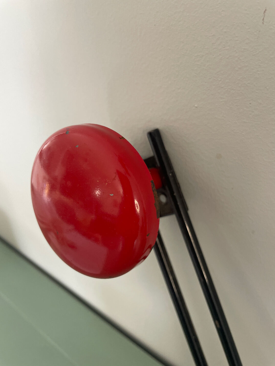 Coat rack, red and black metal hook.