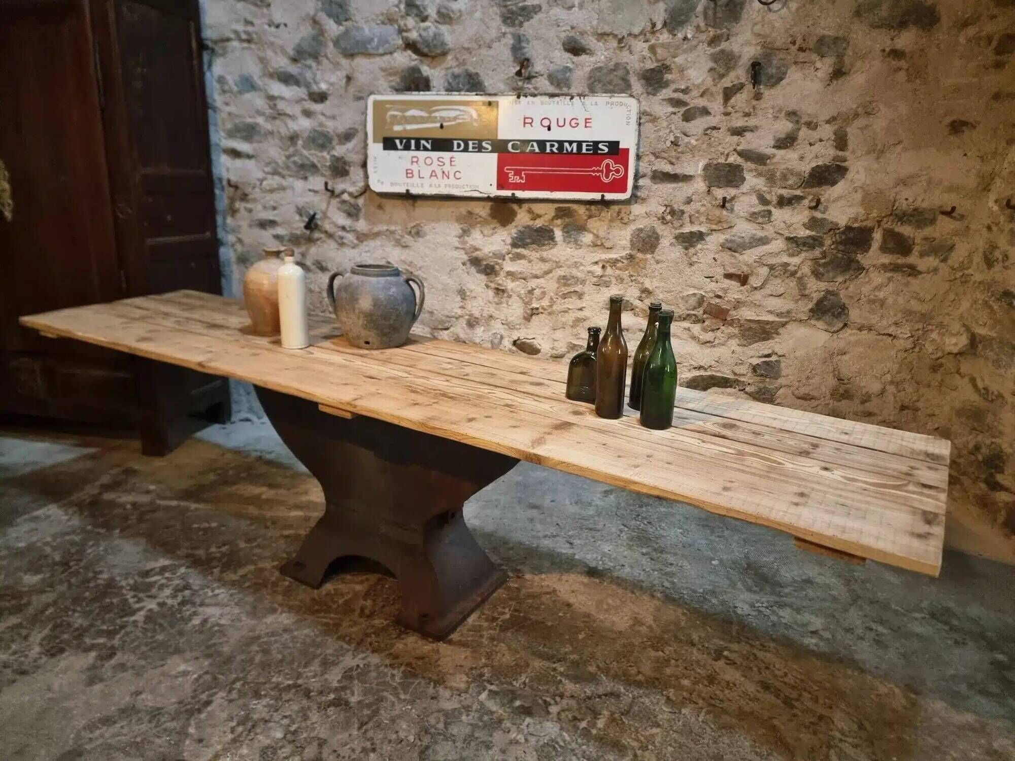 Old French industrial table with a cast iron base and a pine top.