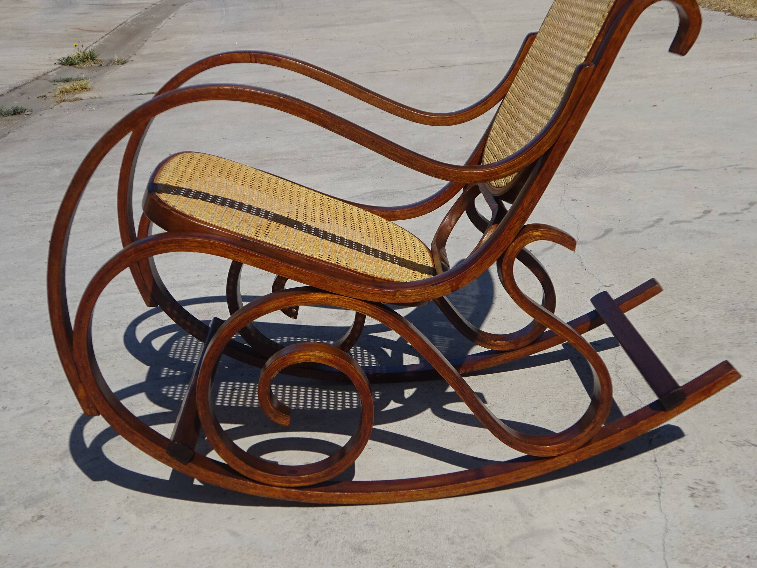 Vintage wooden rocking chair with caning