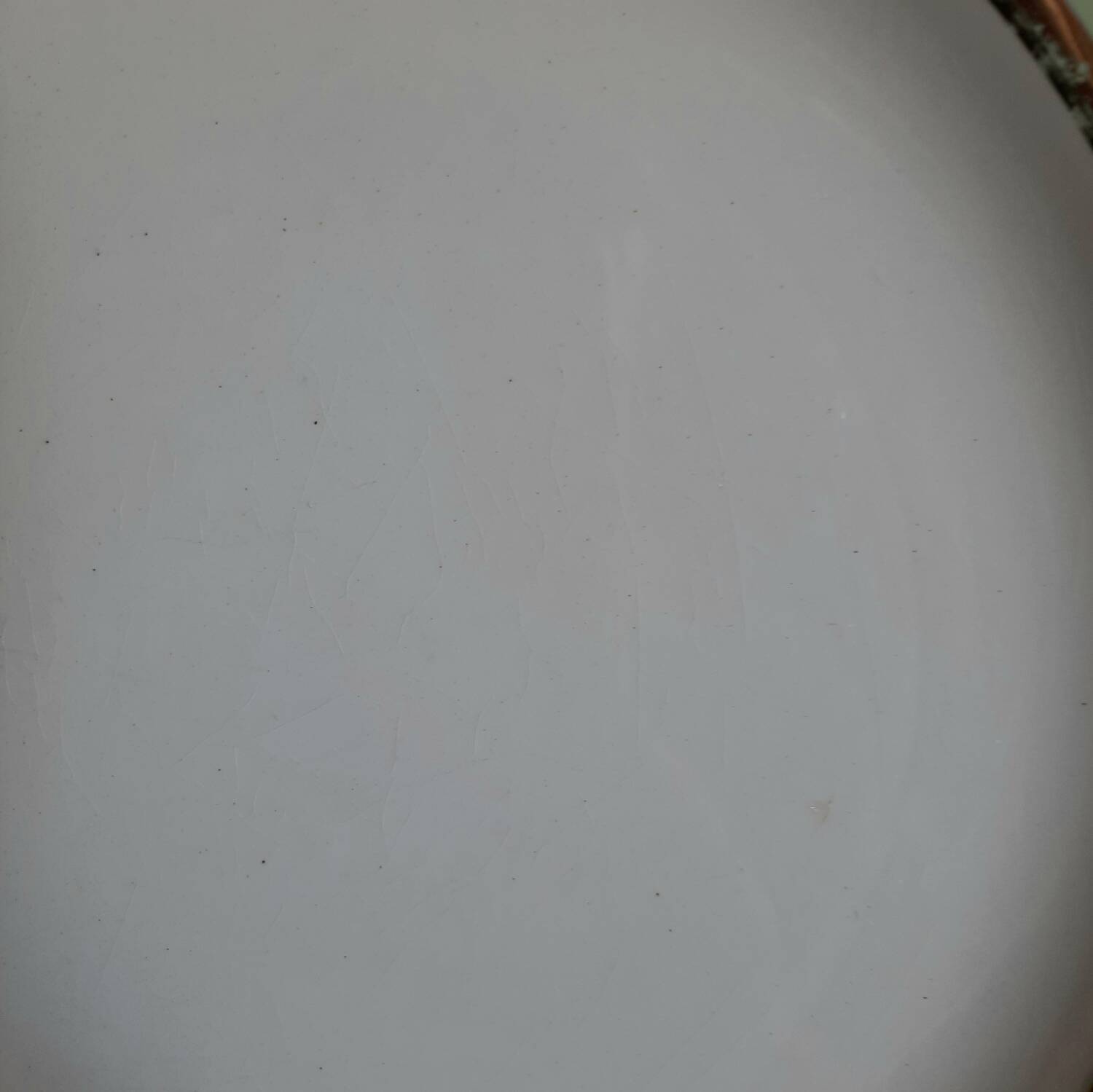 Old mismatched earthenware dinner plates with gold accompanied by a dish