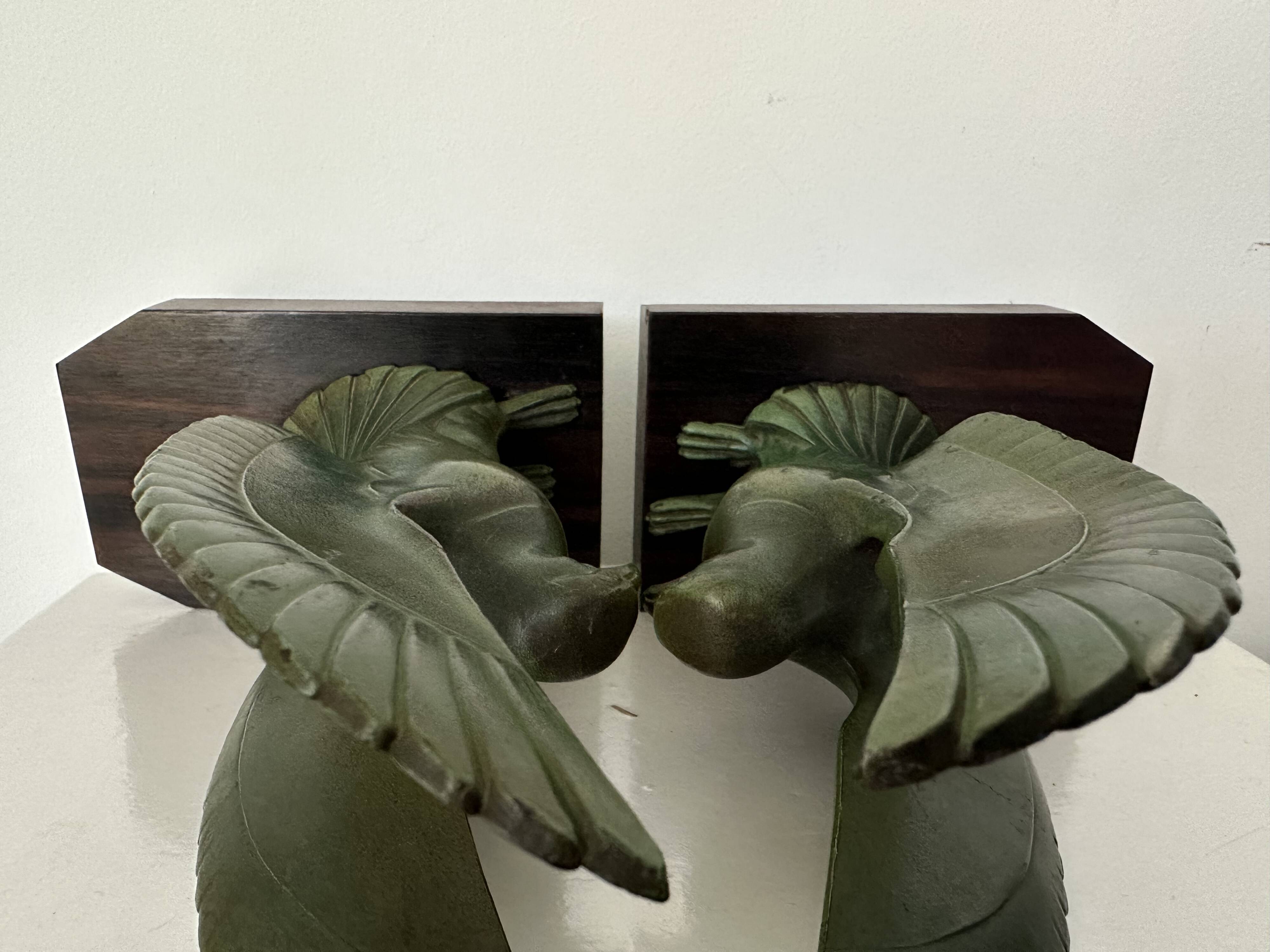 Pair of eagle bookends in green patina regula with rosewood base