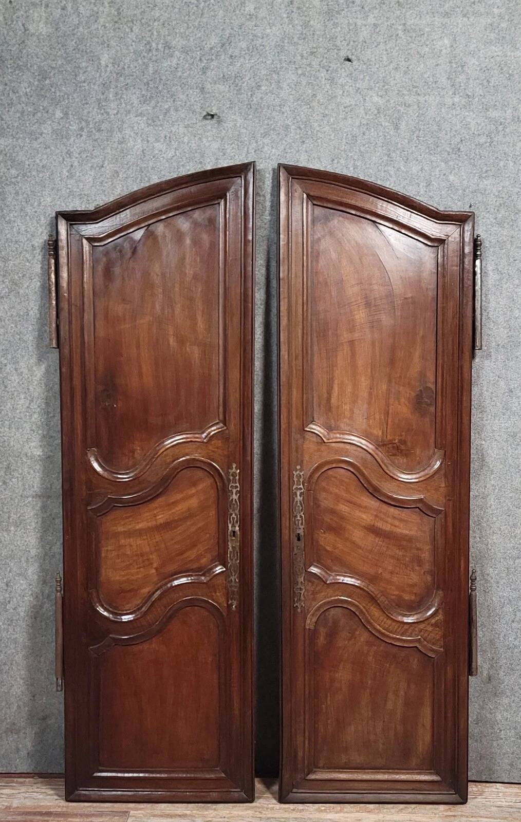 Pair of Louis XV period molded doors in solid walnut