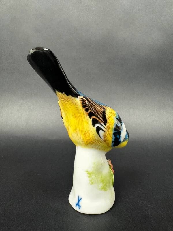 Porcelain figurine of a polychrome bird on a vintage floral base