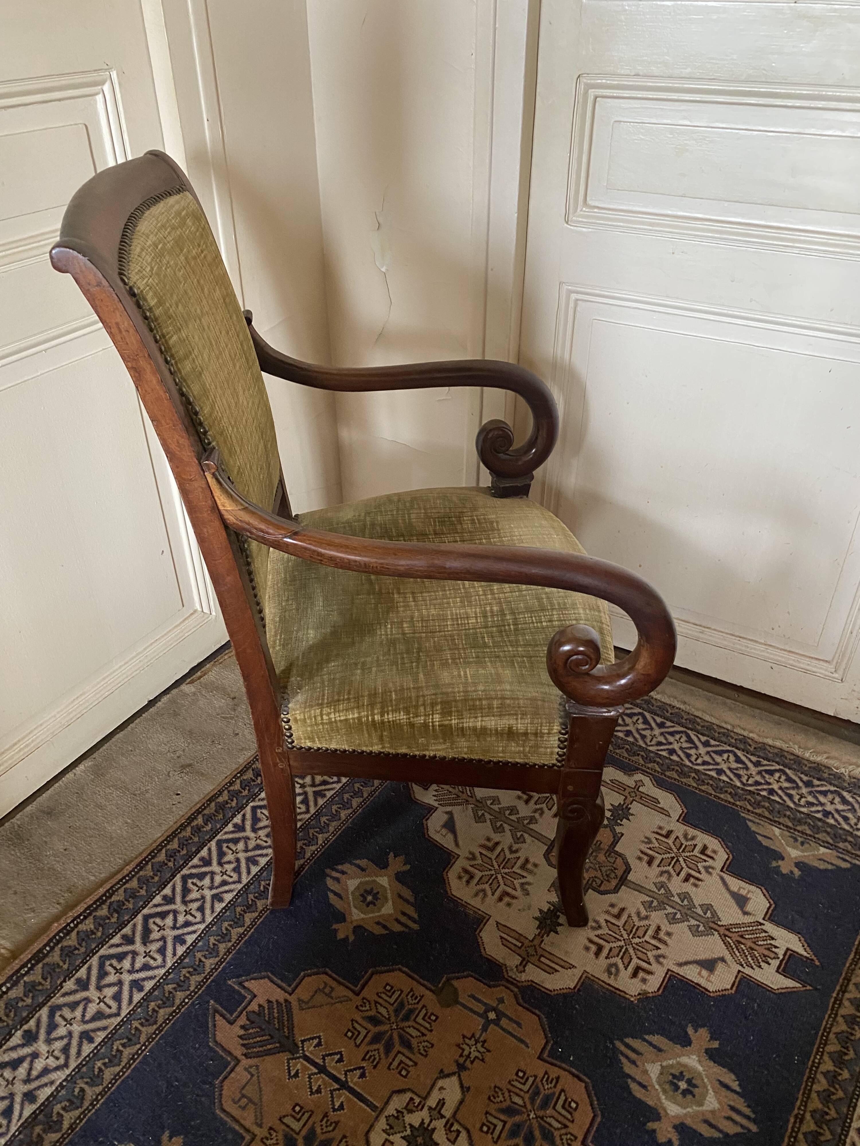 Armchair with a scroll, upholstered in green velvet