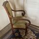 Armchair with a scroll, upholstered in green velvet