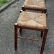 Paire de tabourets années 50 en bois et assise paillée