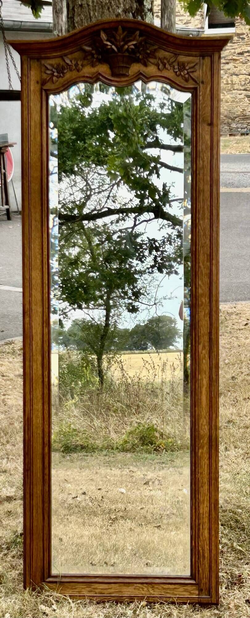 Large and old bevelled framed floor mirror.