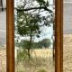 Large and old bevelled framed floor mirror.