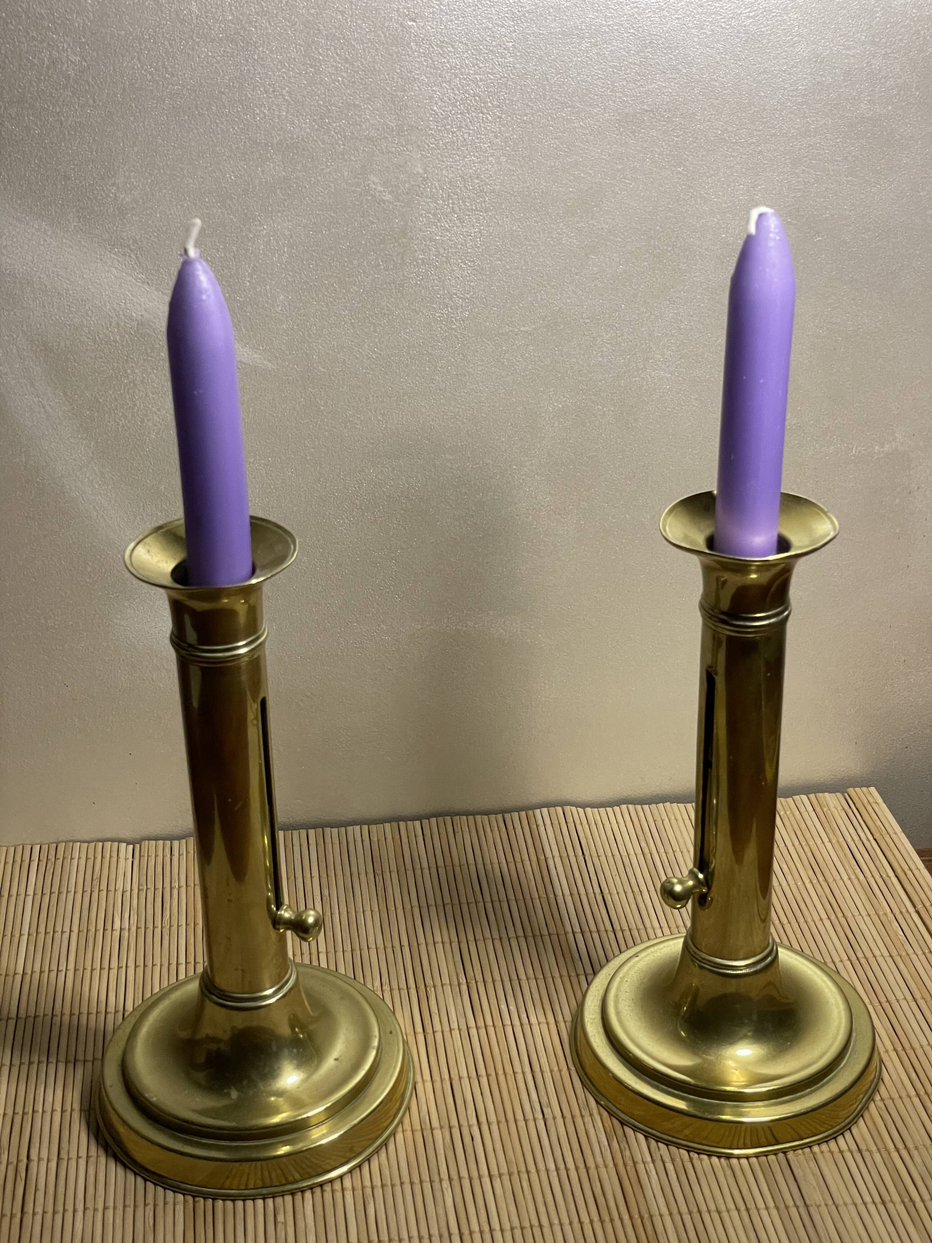 Duo of brass push candle holders