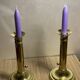 Duo of brass push candle holders