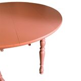 Round wooden table with folding sides