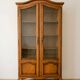 Antique wooden display cabinet with glass doors.