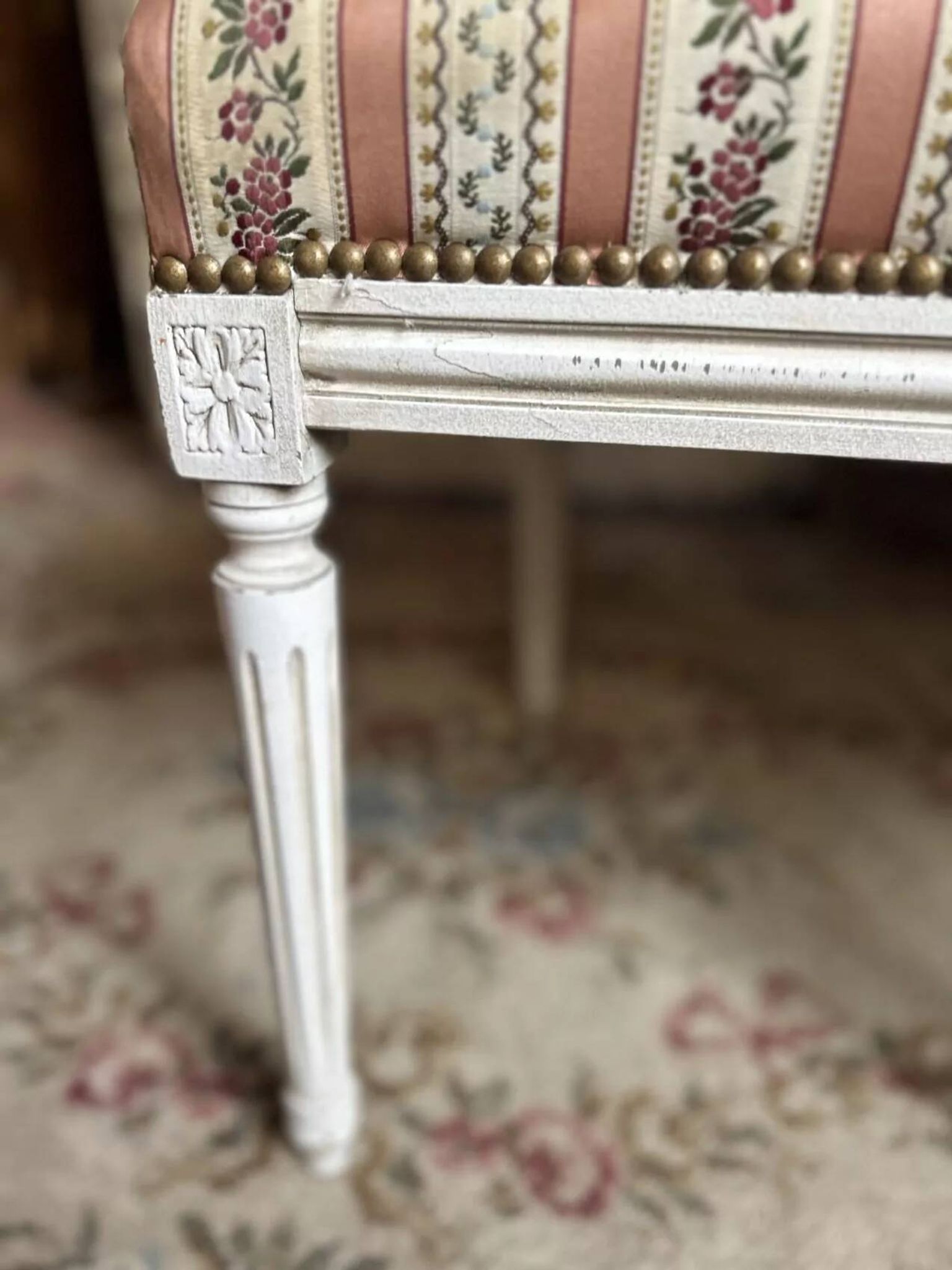 Pair of Louis XVI style chairs in painted wood and satin, classic elegance.