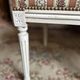 Pair of Louis XVI style chairs in painted wood and satin, classic elegance.