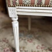 Pair of Louis XVI style chairs in painted wood and satin, classic elegance.