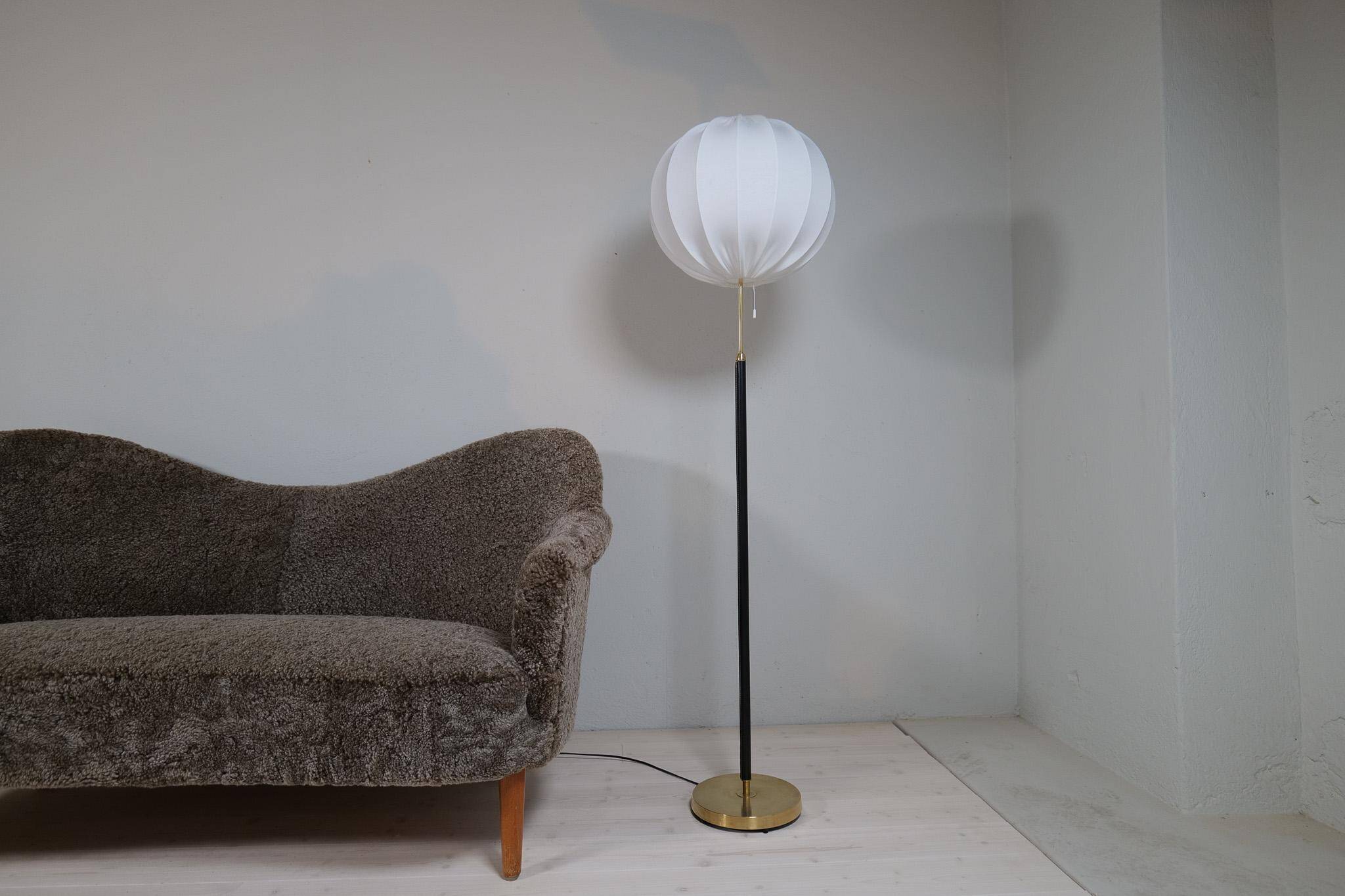 Mid-century black leather and brass floor lamp by Falkenbergs Belysning, Sweden, 1960s.
