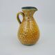 Large yellow ceramic pitcher in the Accolay style