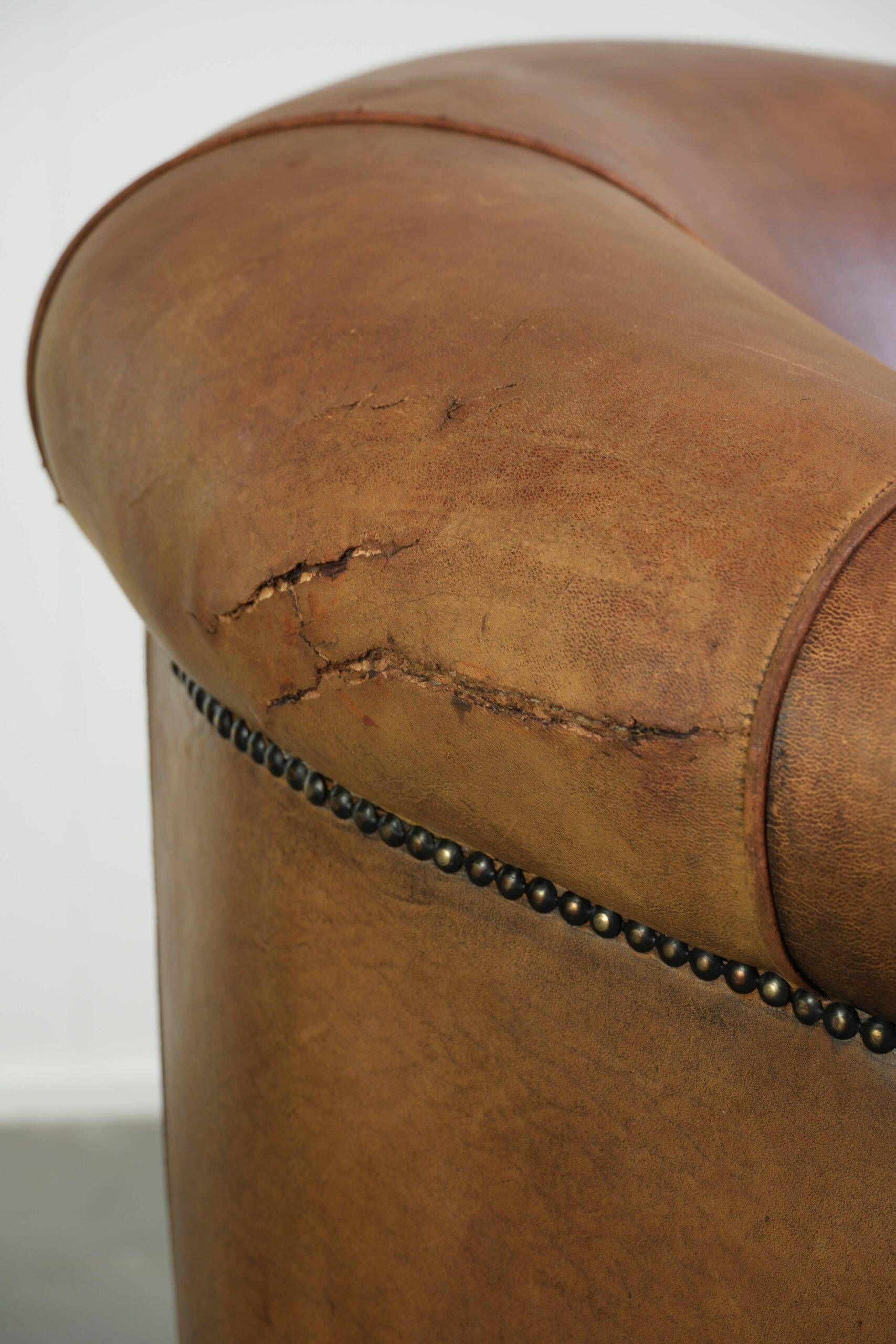 Aged sheepskin clubchair with beautiful vintage patina and comfortable seat