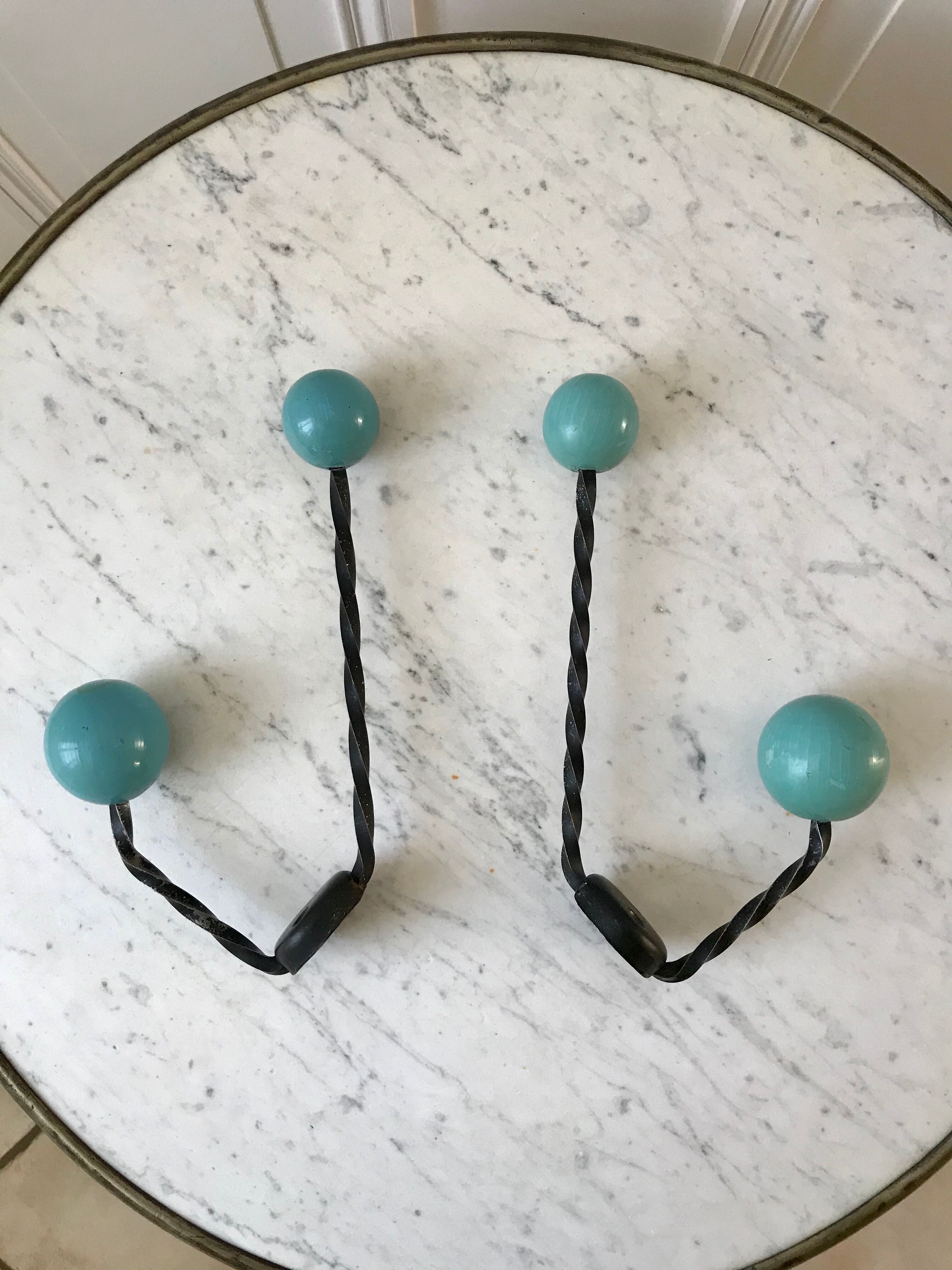 Duo of hooks balls in blue wood and black iron 60s