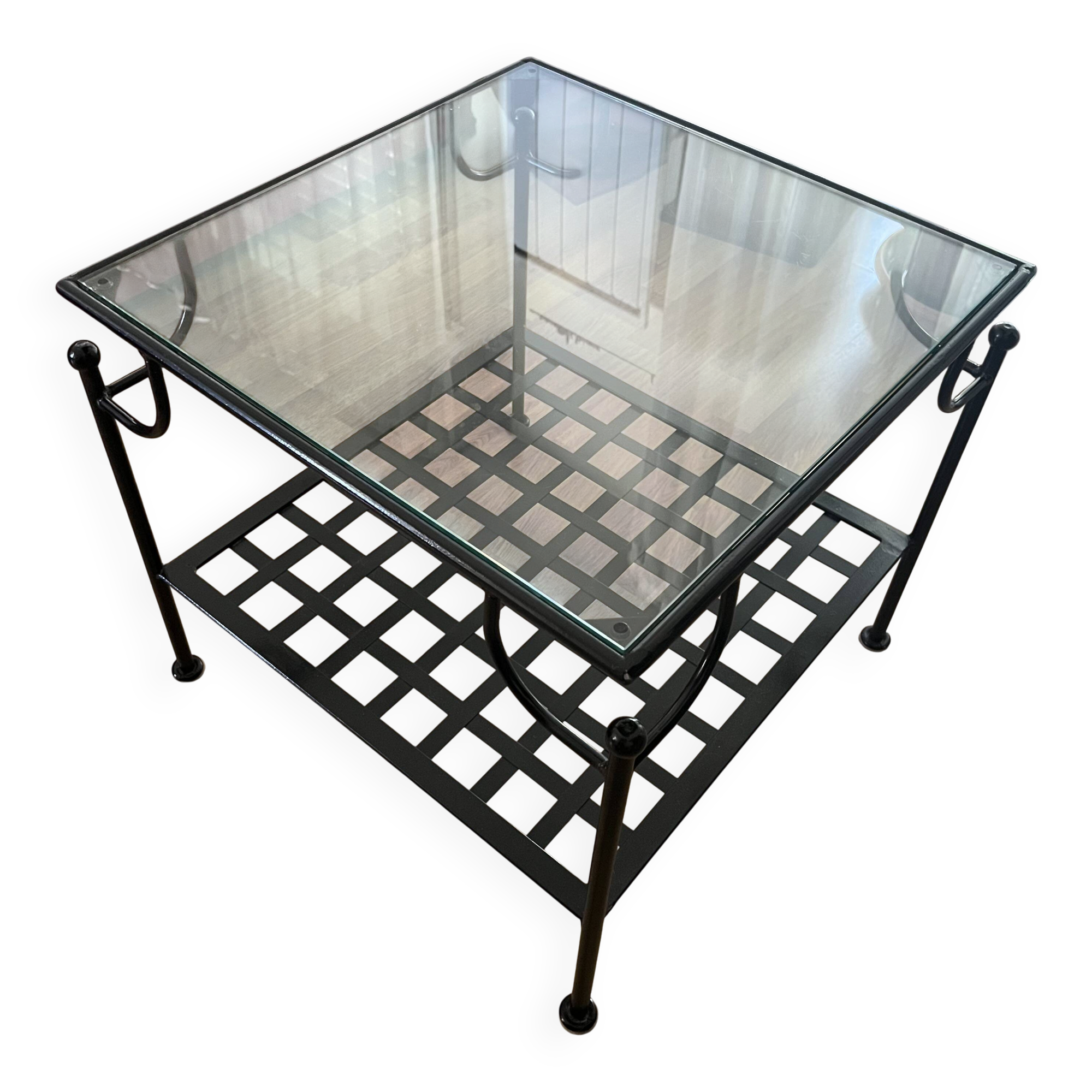 Coffee table with a glass top and black metal frame.