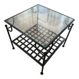 Coffee table with a glass top and black metal frame.