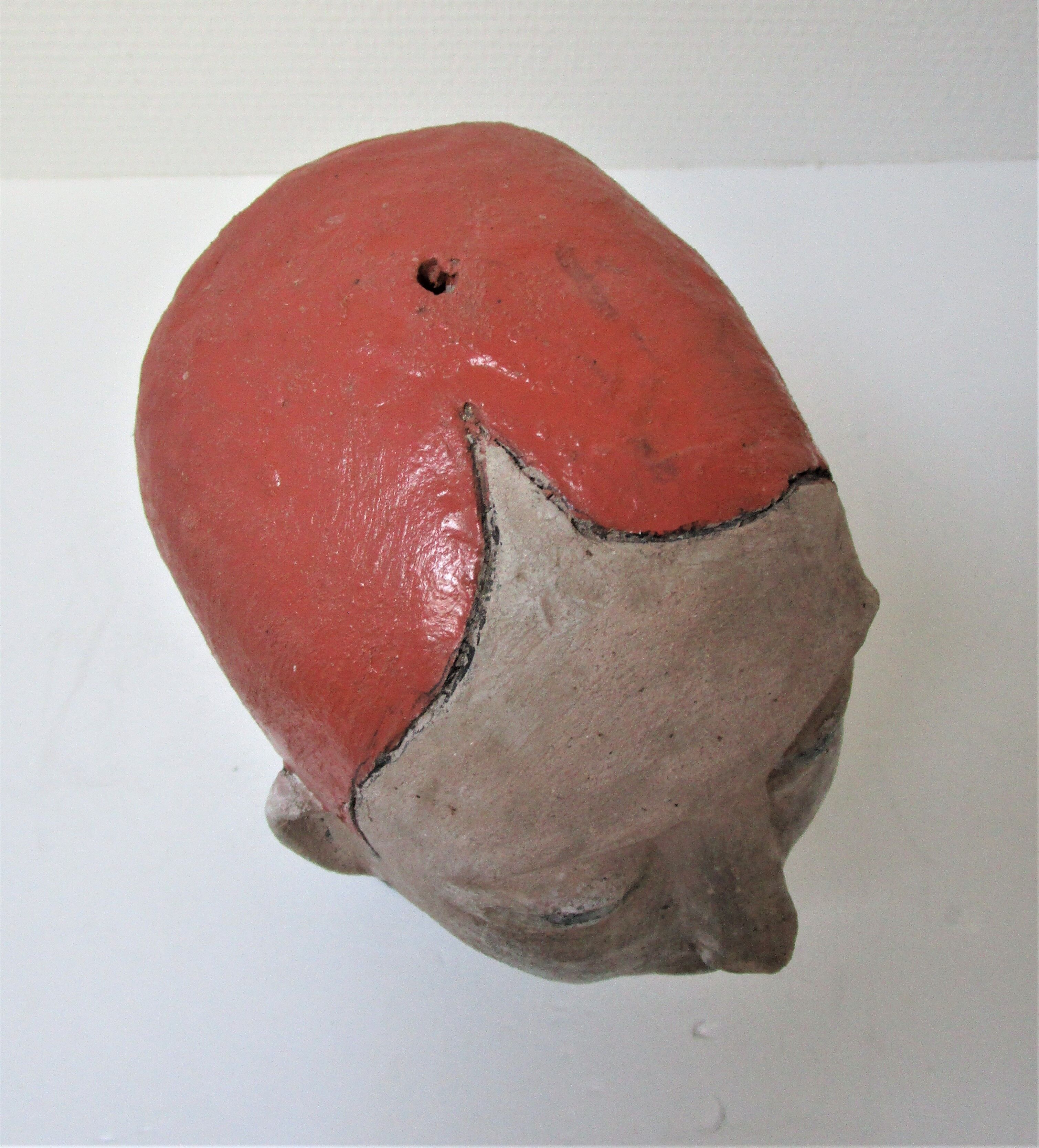 Redheaded boyish woman modeled in earth signed 60/70 years