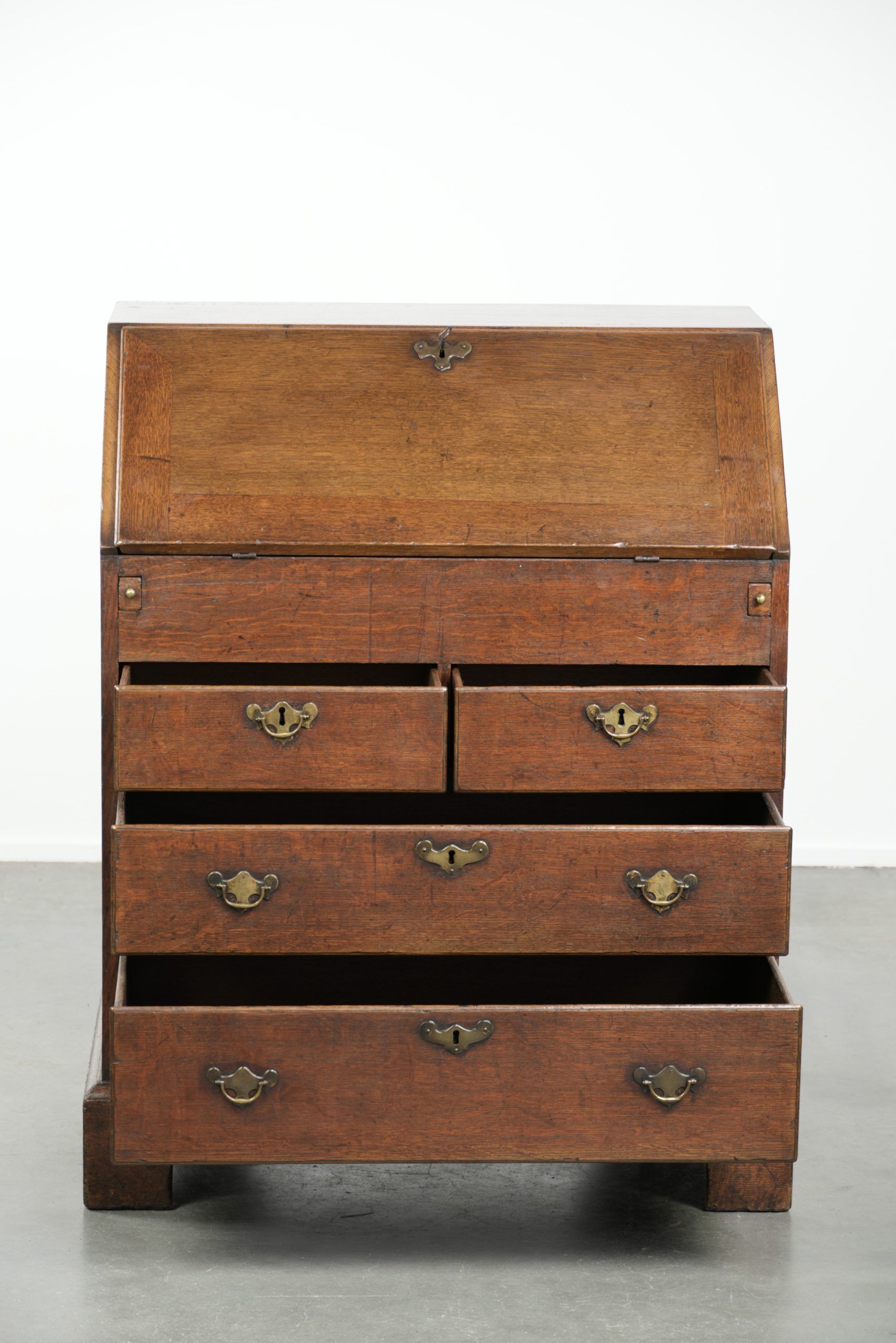 Antique English oak secretary from the 18th century with a stepped interior