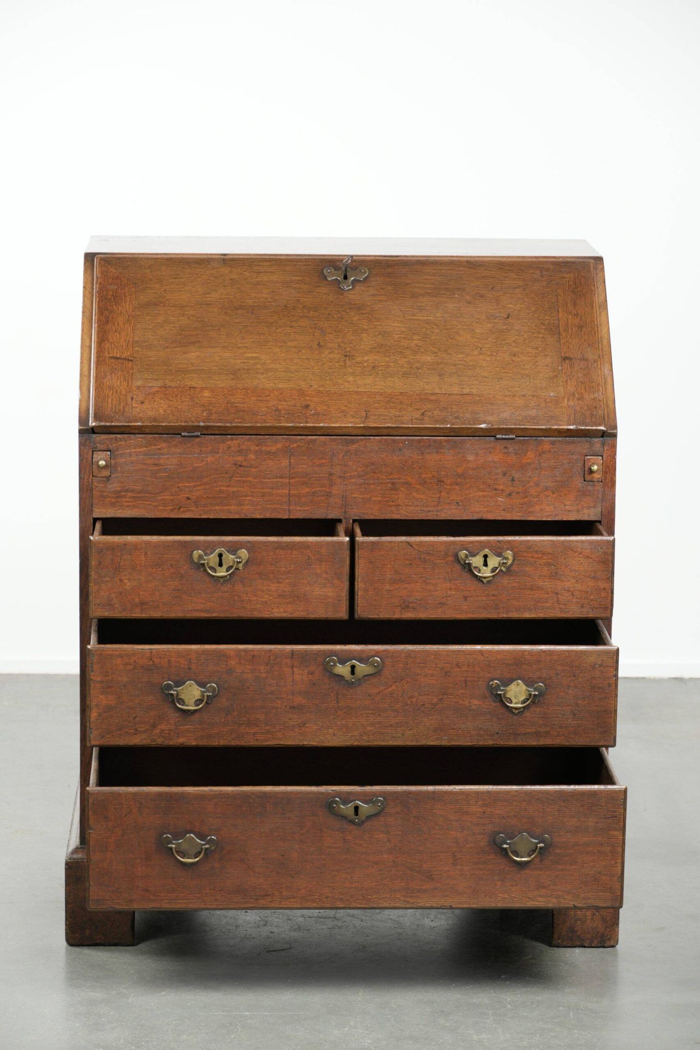 Antique English oak secretary from the 18th century with a stepped interior