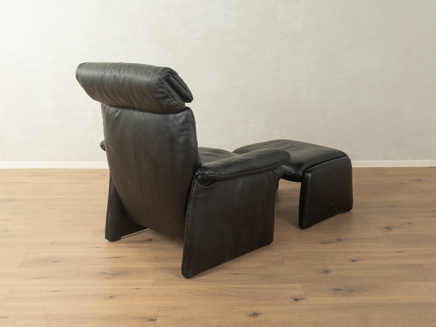 1980s cor armchair and ottoman in black leather