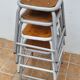 Set of four stackable industrial tubular metal and wood stools