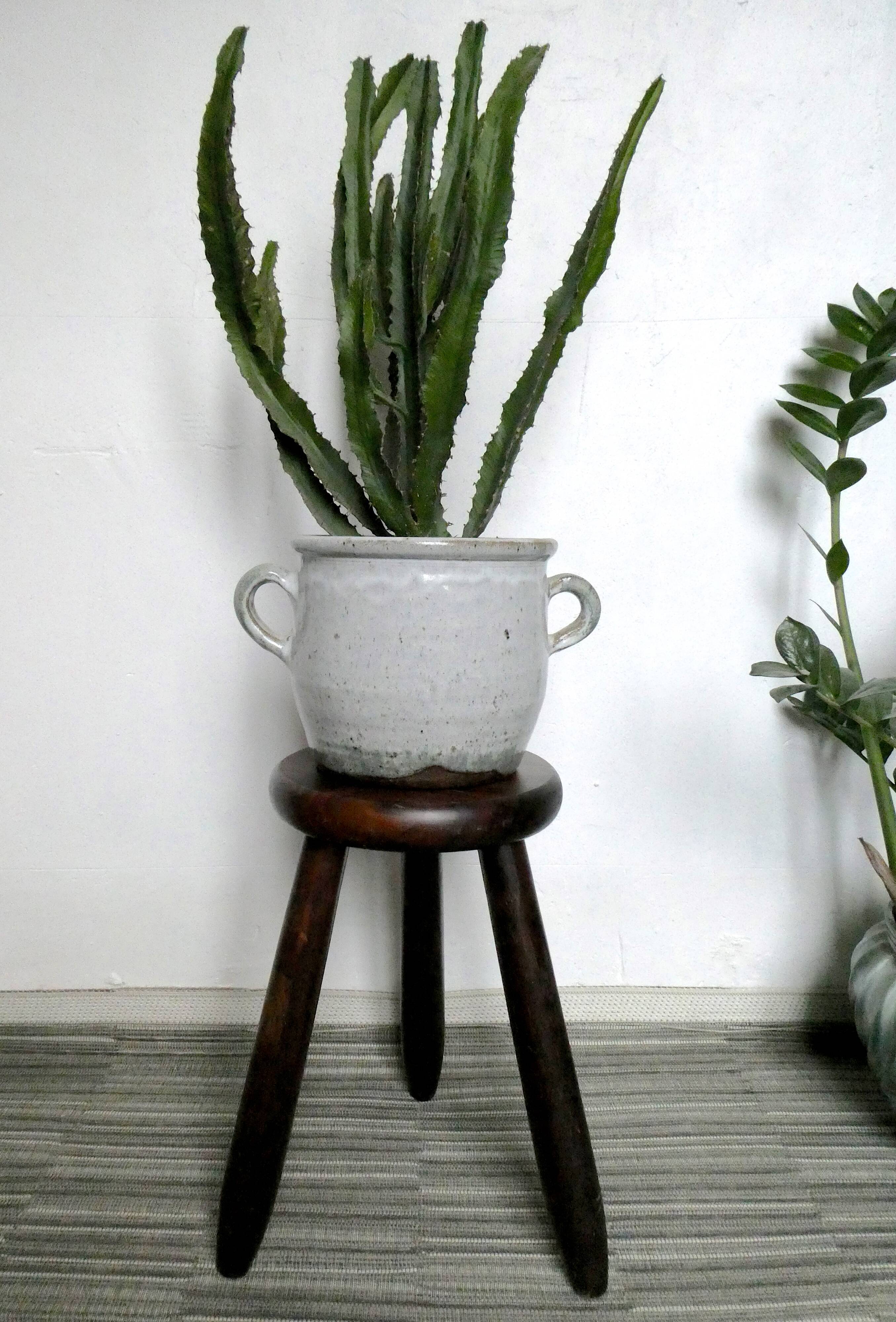 Dark wooden tripod stool