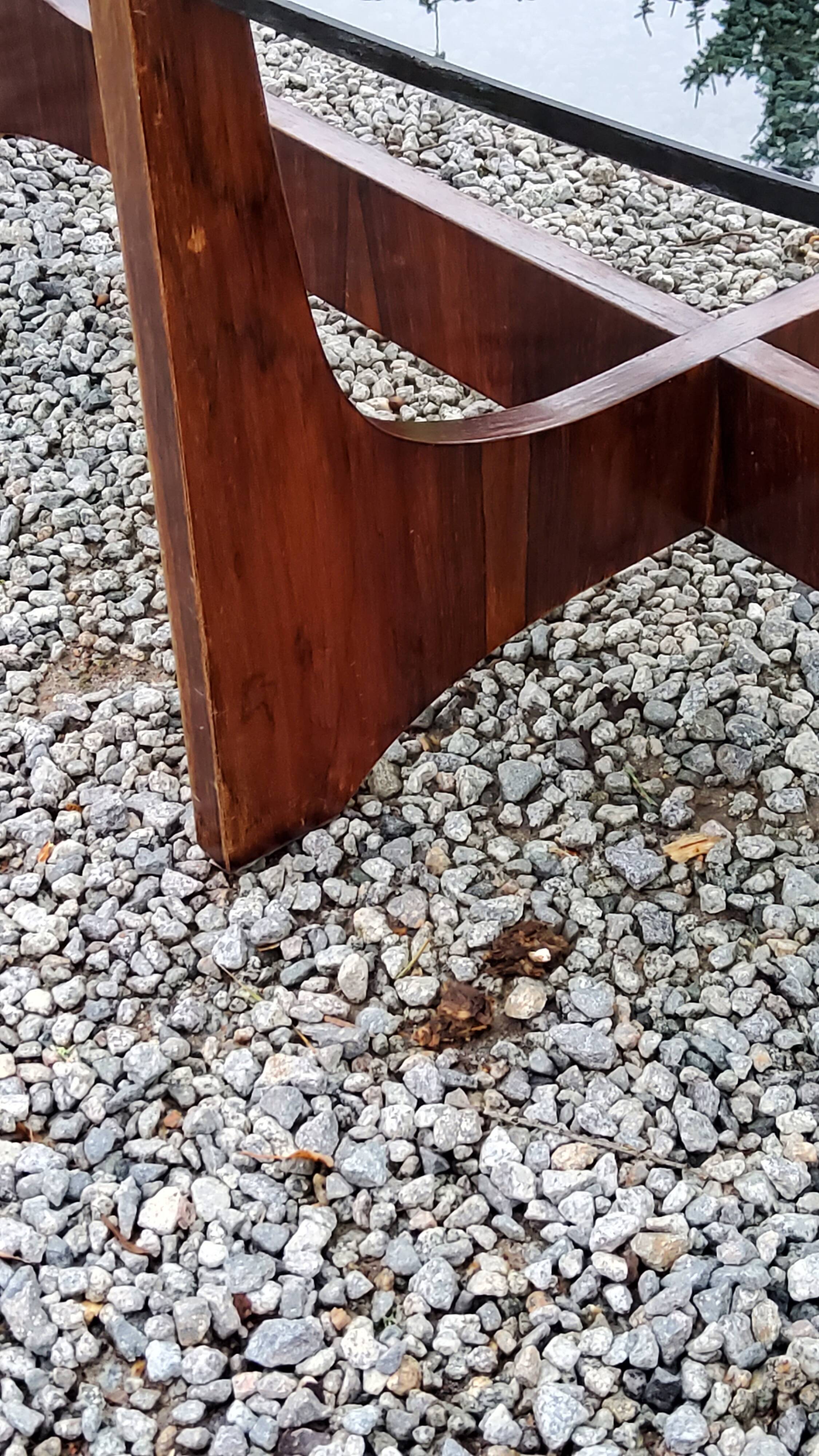 Designer coffee table by Hugues Poignant in rosewood and smoked glass from the 70s