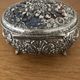 Metal jewelry box inside felt red floral decorations