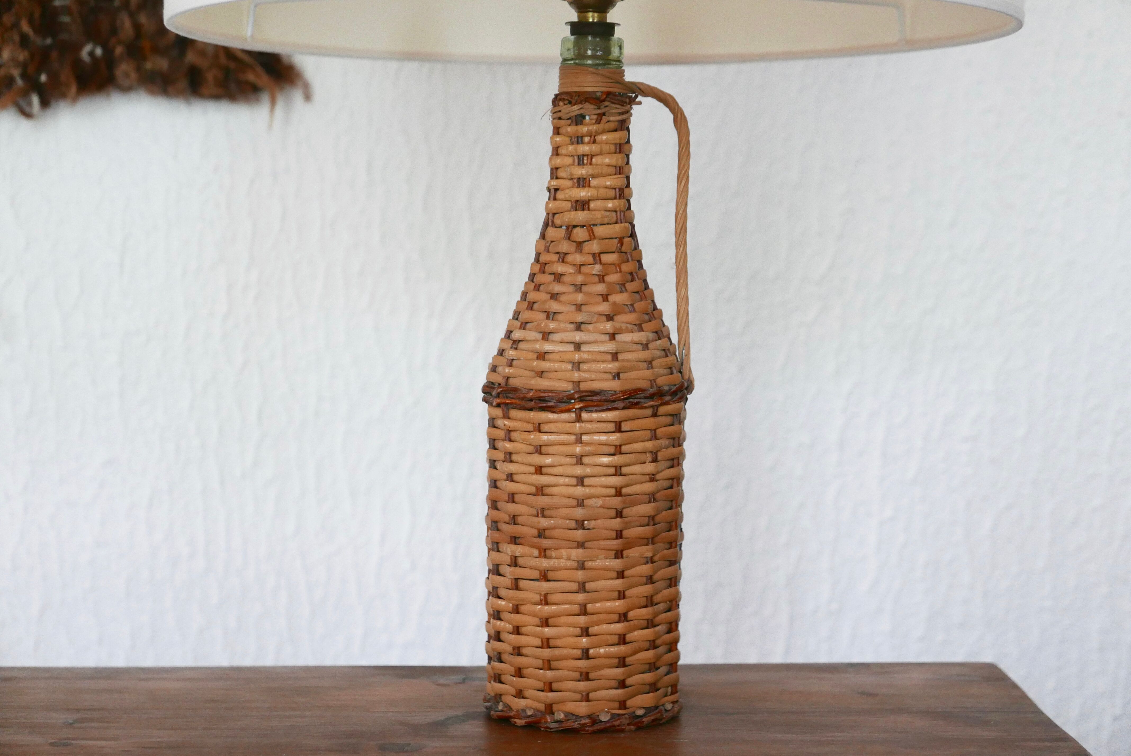 bottle lamp covered with wicker, white drum lampshade, 70s